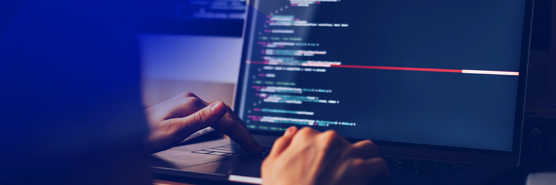 Person writing a code on laptop